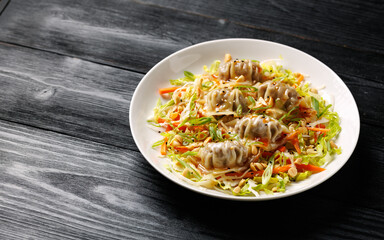 Gyoza Salad or Dumpling Salad with fresh vegetables, nuts and herbs. Asian food