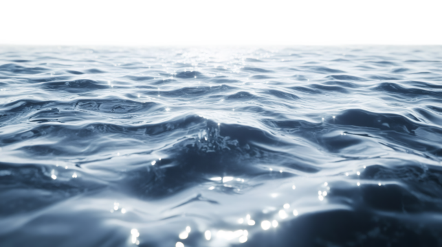 Gentle waves sparkling on clear water, reflecting bright sunlight across tranquil ocean surface under clear summer sky