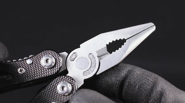 Macro Close up of a multi tool pliers and other pocket tools
