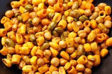 Sweet chilli Crunch protein packed mix of baked corn pieces, edamame beans, chickpeas and corn hoops. Healthy snack concept