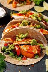 Fried halloumi fajitas with pan roasted onions and bell peppers, avocado guacamole and pickled jalapeno peppers