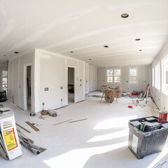 Unfinished house interior under construction. Drywall is installed, but painting and flooring are yet to be completed.