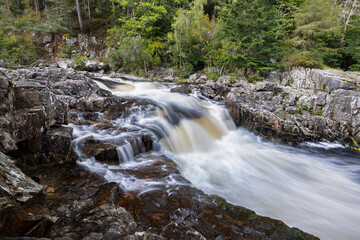 Scenic View of Linn of Tummel Waterfall in Perthshire, Scotland, with Fast-Flowing White Water Tumbling Over Jagged Rocks, Surrounded by Verdant Forest and Natural Scottish Wilderness