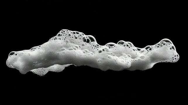 Abstract close-up of a white foam texture on a black background, demonstrating intricate bubble formations and fluid dynamics in a minimalistic style for artistic applications.