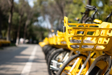 row of parked bicycles at a modern bike-sharing station