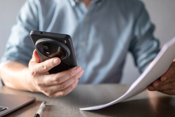 asian man using smart phone in modern office