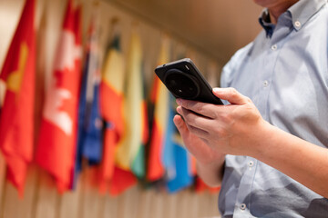 asian man using smart phone with flag of the world