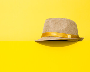 Yellow brimmed hat on yellow. 