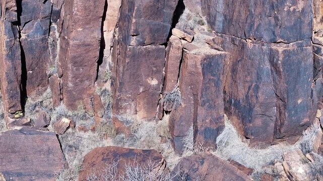 Aerial Virgin River gorge volcanic cliff Utah slide close. Southwestern desert Utah. Land of Shivwits Band Paiutes, Native American Indians. Geological erosion. Red sandstone black volcanic canyon.