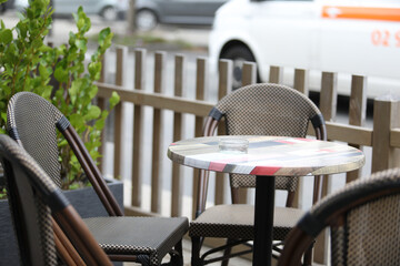 Empty street caf&eacute; with vacant tables and chairs during the off-season. Quiet urban scene expressing calm, stillness, and peaceful atmosphere in a city public space.