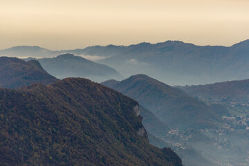 top view of the Como Lake from the Resinelli Piani in a foggy morning, Lecco province, Italy