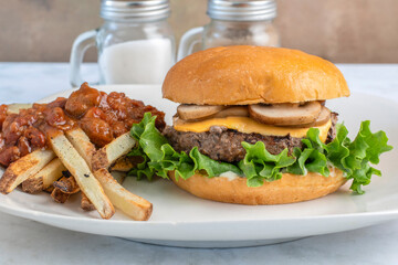 cheese burger top with mushrooms  served with chilli fries