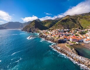 Obraz premium a stunning aerial view of a coastal village with colorful buildings nestled between mountains and turquoise waters perfect for travel real estate and tourism projects