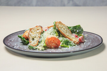  a plate of Caesar salad. The salad consists of crisp romaine lettuce leaves, golden-brown croutons, shredded parmesan cheese, and slices of grilled or roasted chicken.