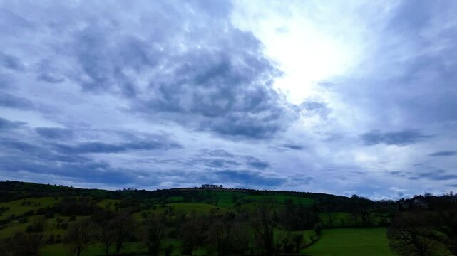 Timelapse of the clouds at dusk over green hilly field in Matlock town, Derbyshire, UK