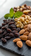 Closeup of assorted nuts and raisins on dark slate