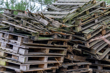 old wooden pallets lying in a pile. damaged shipping pallets.