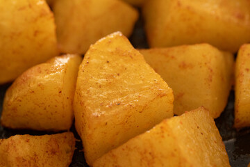 Golden roasted potato wedges with crispy seasoning and spices