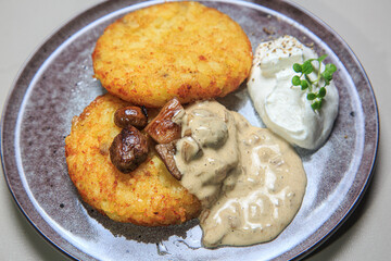 The combination of the crispy potato pancakes, the savory mushrooms, the creamy sauce, and the light whipped cream
