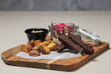 The image shows a rustic and appetizing food presentation on a wooden cutting board. 