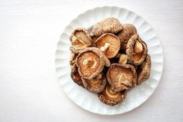 Dried mushrooms in white plate , Dried shiitake mushrooms on white background	