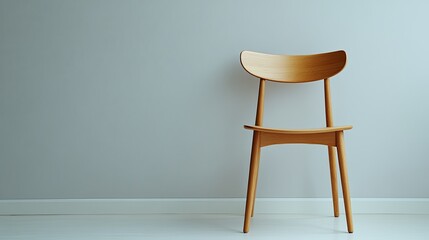 A clean photo of a minimalist wooden chair styled on a light gray background. background