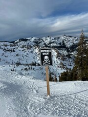 Mountain landscape with 'Experts Only' sign