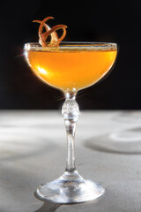 The image shows a beautifully crafted cocktail served in a stemmed glass. 