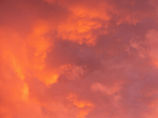 Dramatic sky with clouds. Mysterious abstract background pattern texture. Many yellow and orange tones and patterns of clouds.
