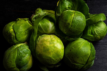 Close-up of brussels sprouts on a table and black background, horizontal with copy space
