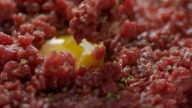 Mixing Steak Tartare with Egg Yolk