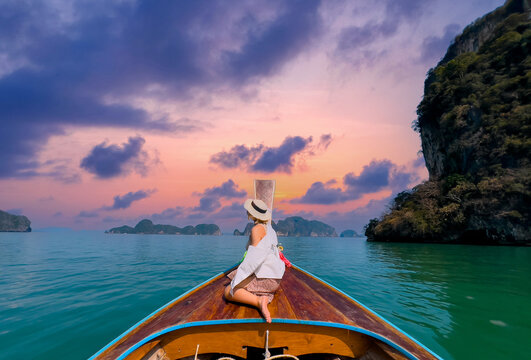 Scenic phang nga bay at sunset with woman on longtail boat in Thailand, concept travel thai