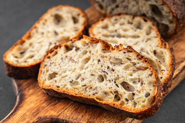 Grain bread sunflower, chia, flax seed, cut oats fresh tasty food dish delicious gourmet food background on the table rustic food top view copy space vegetarian and vegan food