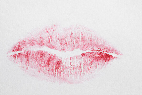 faint red lipstick print isolated on white