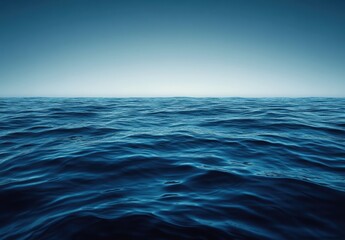 Fototapeta premium Tranquil Ocean Surface with Gentle Waves Under Clear Blue Sky, Perfect for Serene Coastal Themes and Nature Photography Projects