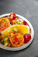 Candied peel and fruit orange, kumquat, tangerine, cherry, mango and others Sugar-coated fruit fresh tasty food dish delicious gourmet food background on the table rustic food top view copy space