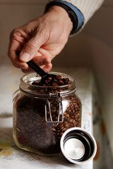 Scooping Coffee Beans from a Glass Jar