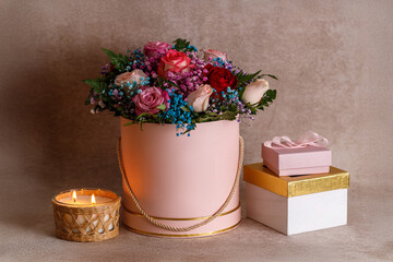 Luxurious bouquet, gift boxes in pink and gold, festive atmosphere