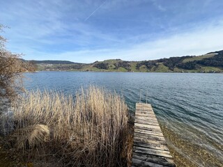 Fototapeta premium Swiss subalpine lake See Ägerisee or Ageri Lake (Ägeri Lake or Aegeri Lake) - Canton of Zug, Switzerland - (Agerisee oder Aegerisee - Kanton Zug, Schweiz)