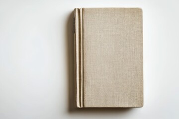 Beige Linen-Covered Book on White Background