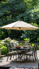 Fototapeta premium Outdoor dining setup under a large umbrella in a serene garden surrounded by lush greenery and blooming flowers