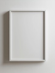 A minimalist white frame hangs on a plain wall, casting subtle shadows. The simplicity evokes a sense of calm and focus