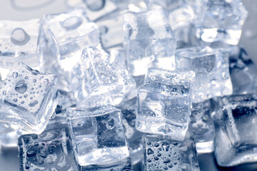 Obraz premium Ice cubes with water drops as background, closeup