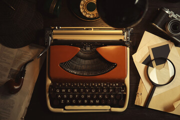 Typewriter, magnifying glass and papers on detective's desk, flat lay