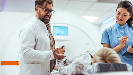 Medical Professionals Assisting Patient in Modern Diagnostic Imaging Room