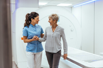 Healthcare Professional Assisting Elderly Woman Near MRI Machine in Hospital Setting