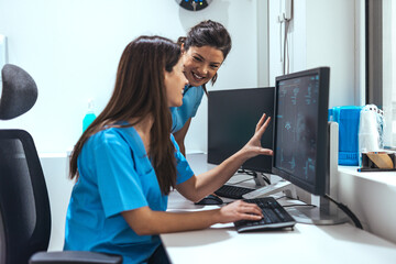 Healthcare Professionals Discussing Patient Data on Medical Software in Office