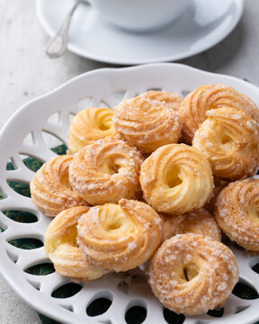 Samanta, typical brazilian sugar covered biscuit with coffee over wooden table