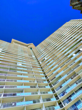 Ilikai Hotel in Oahu, Hawaii, showcases modern architecture against a vibrant blue sky