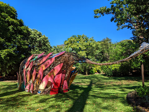 Colorful art installation made from surfboards at Foster Garden in Oahu, Hawaii on a sunny day